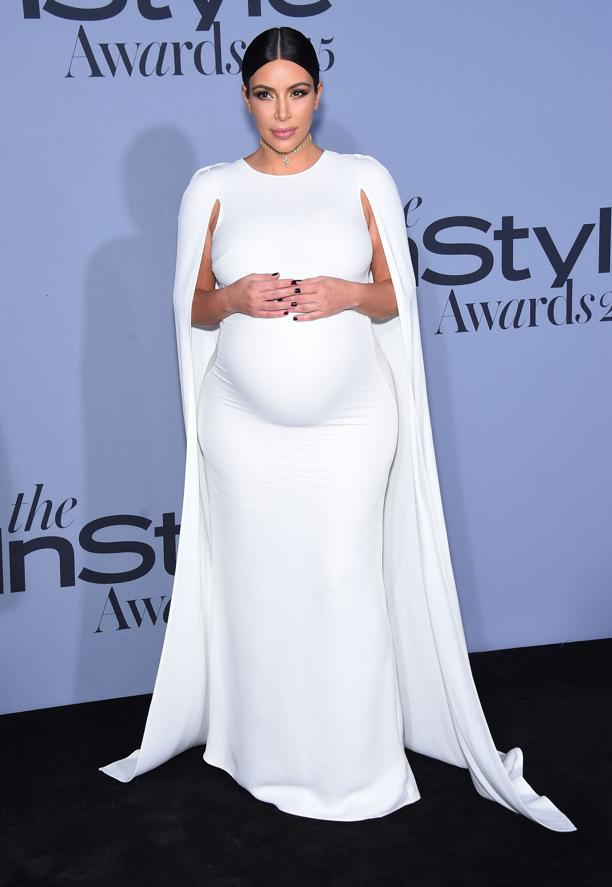 Kim Kardashian holding her pregnant belly 